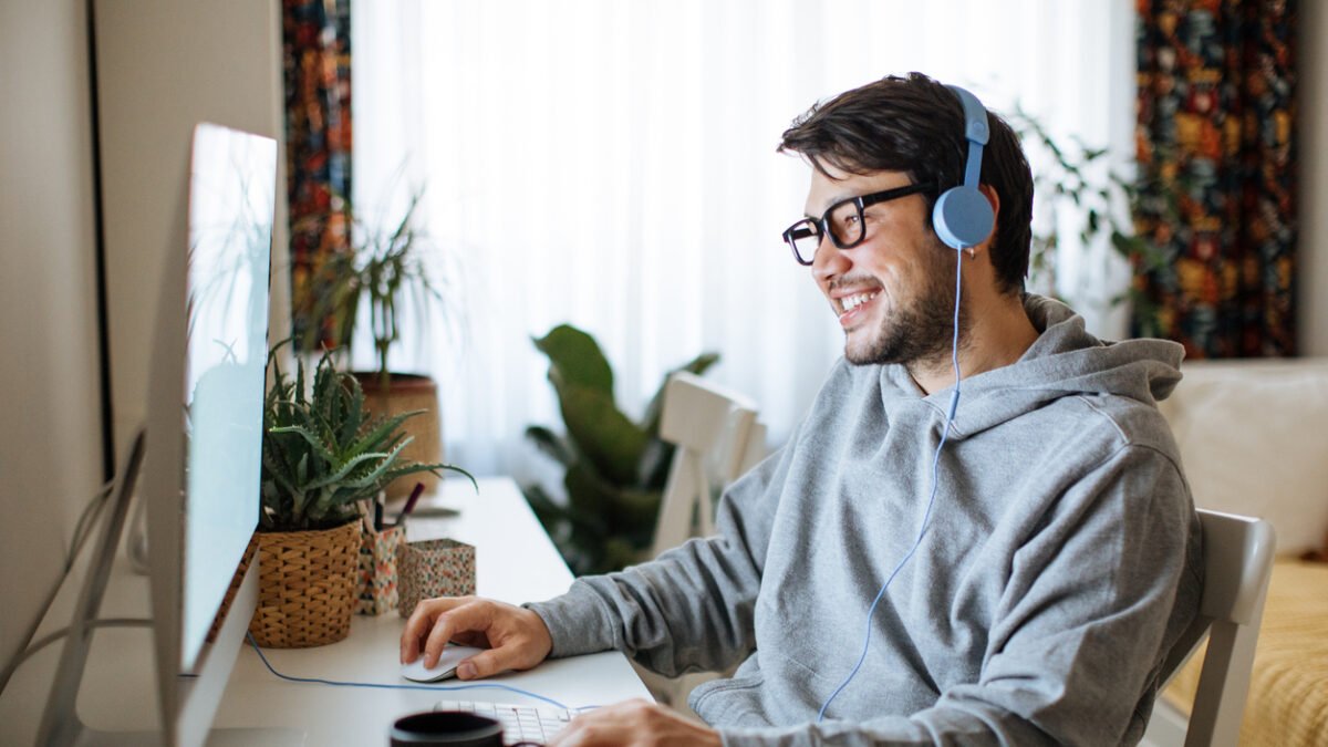 Young men playing video games with desktop